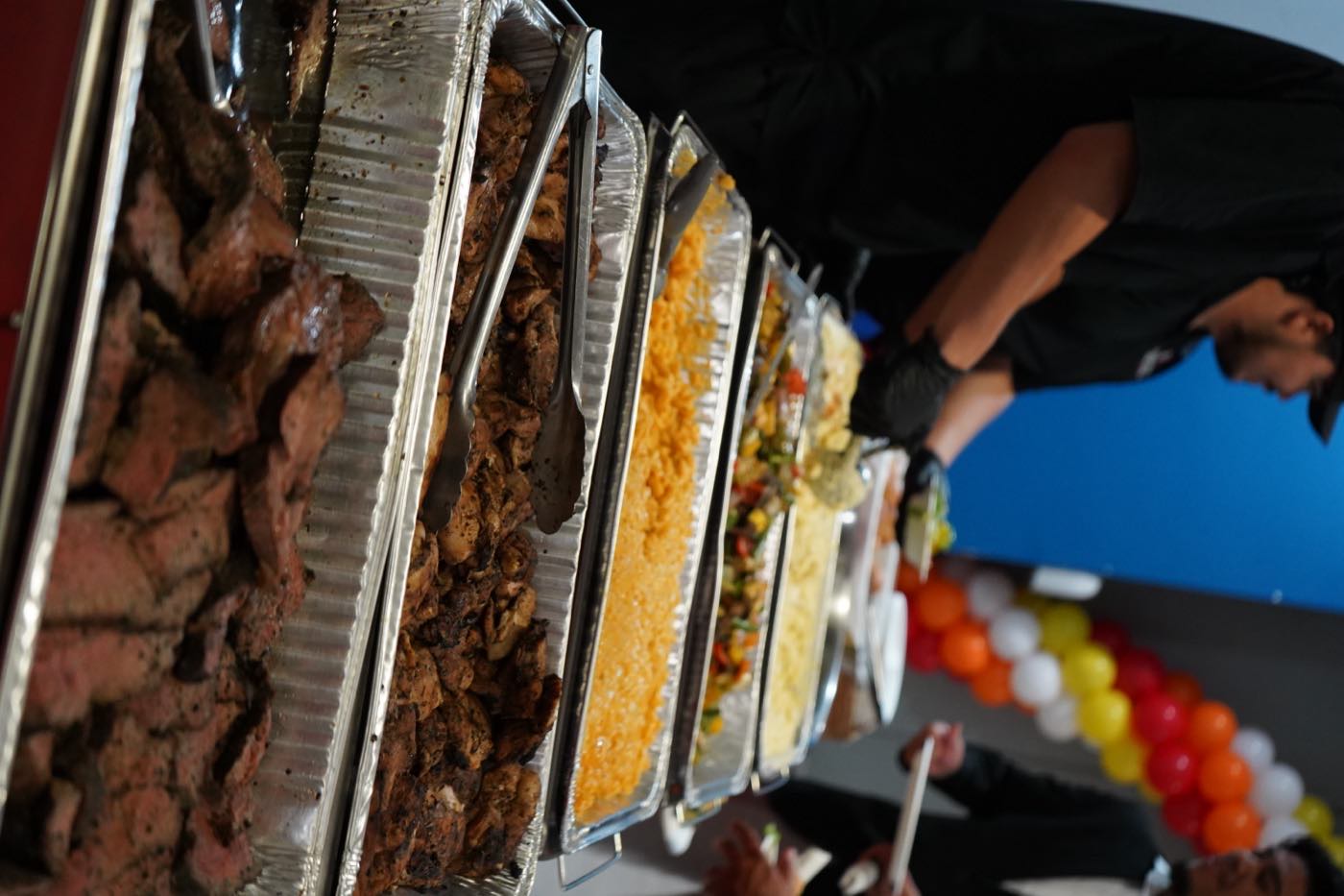 Full BBQ and taco buffet spread at a catered party