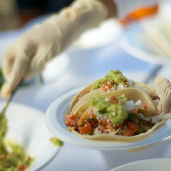 An image showing Carne Asada tacos with pico de gallo, guac, and cheese.