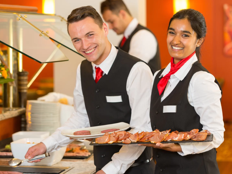 An image showing a dedicated catering team preparing for a graduation party.