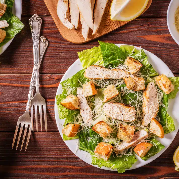 Homemade Chicken Caesar Salad with Cheese and Croutons.