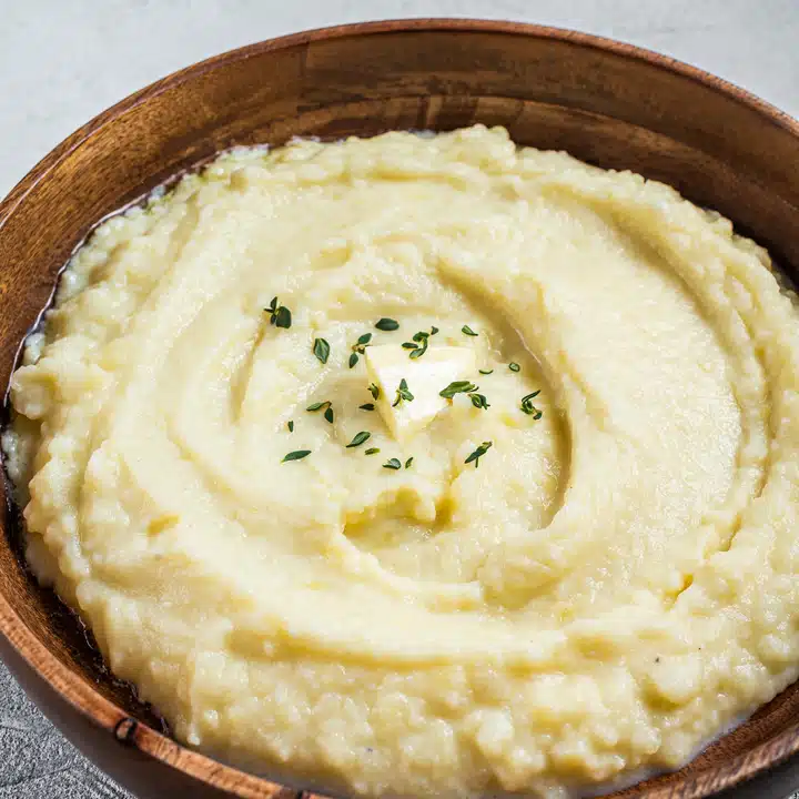 Boiled potato puree, Mashed potatoes in a wooden plate. White b